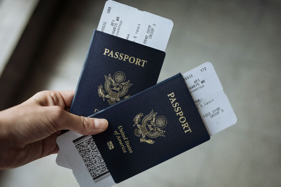 an individual holding passports and boarding passes