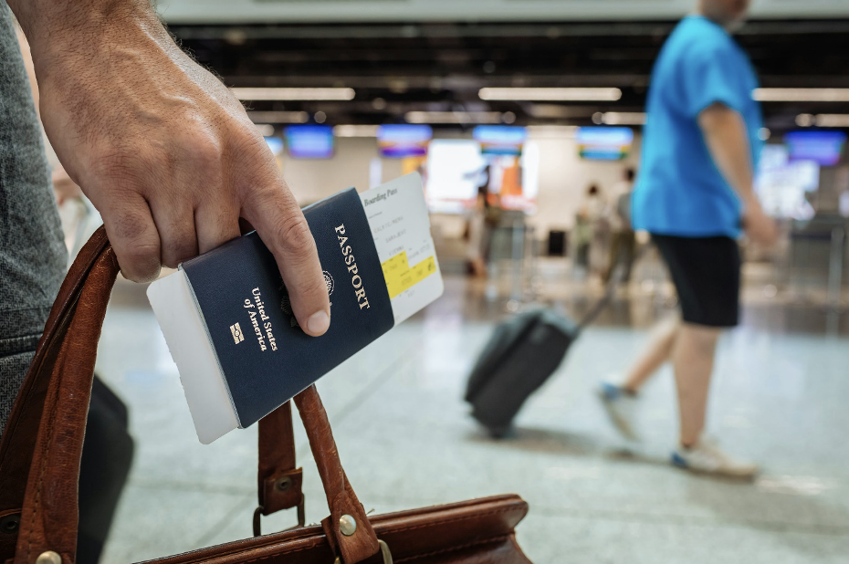 an individual holding a bag and US passport